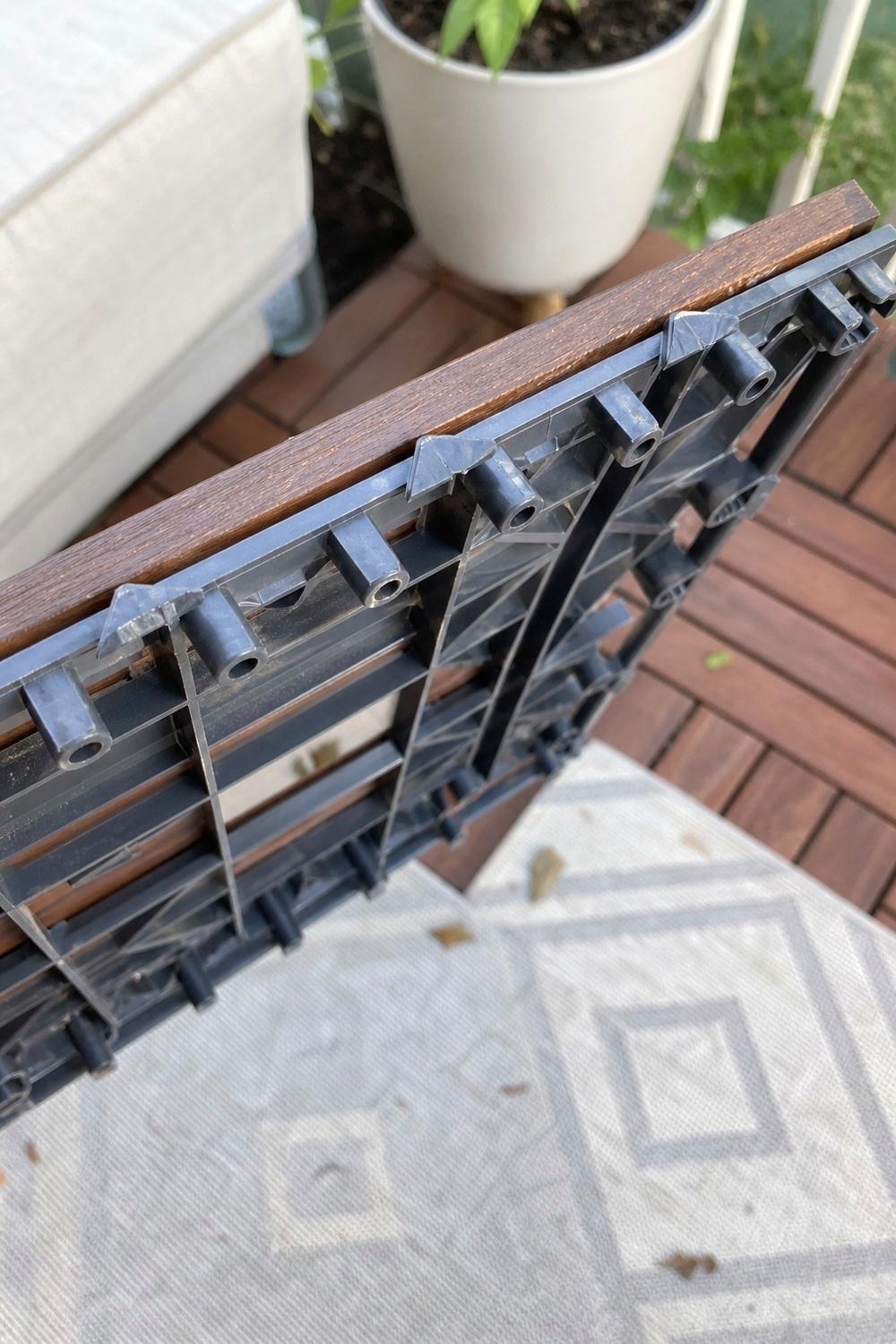 Close comparison of wood look composite tile and turf tile samples side by side
