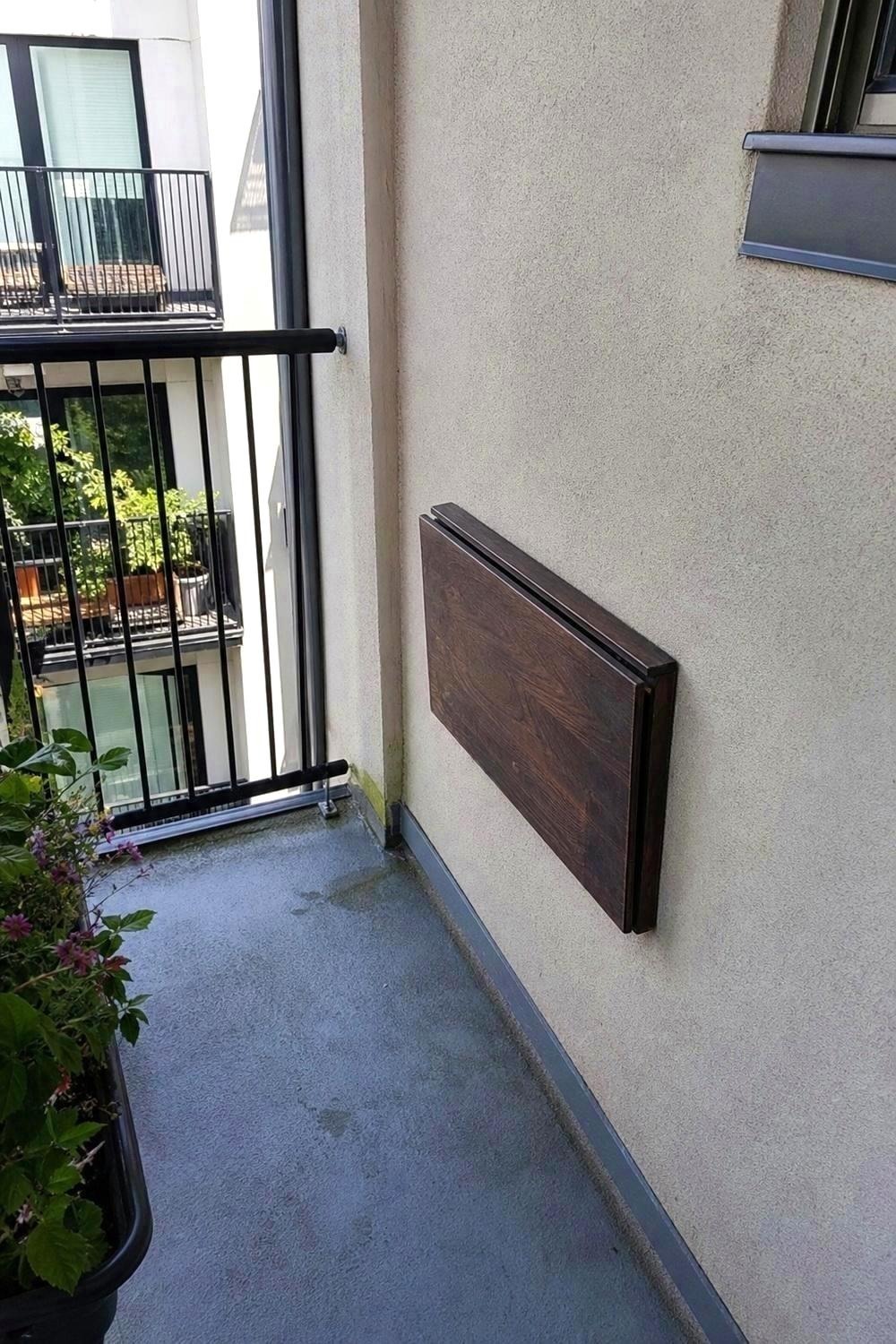 Acacia wood balcony railing table top next to a powder-coated steel frame sample