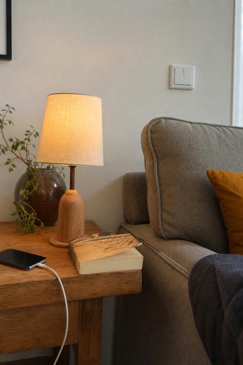 Dimmable touch table lamp glowing warmly on a side table at low brightness
