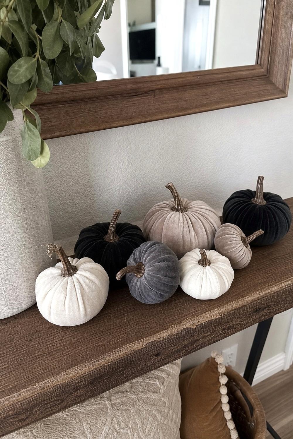 Faux velvet pumpkins in neutral colors grouped on a coffee table