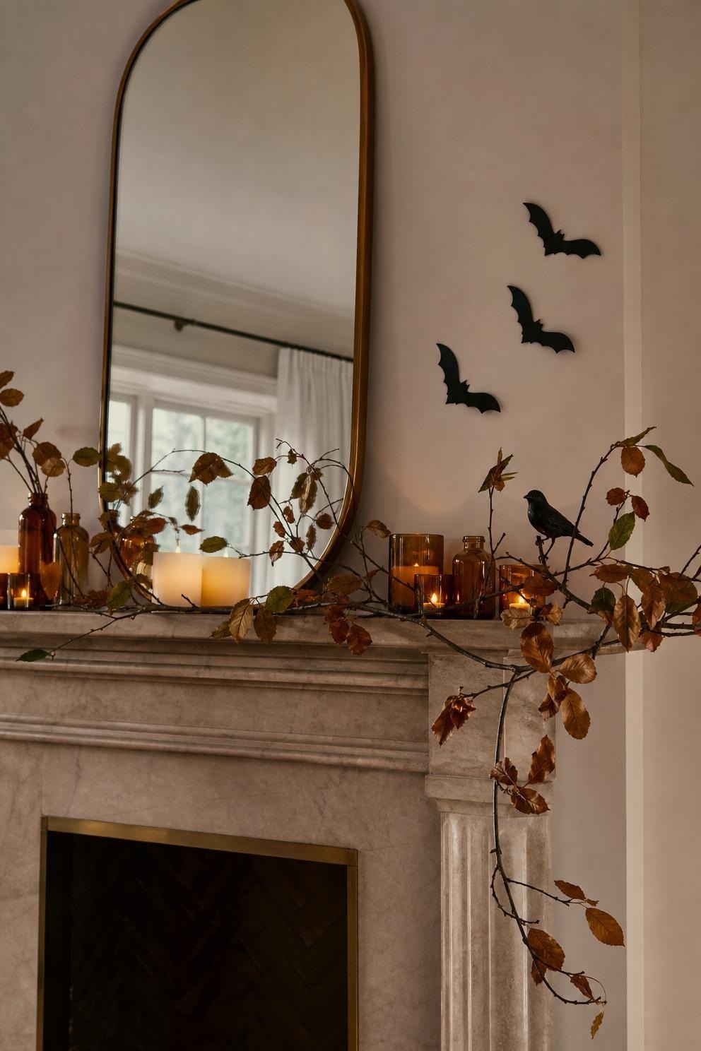 small Halloween accents layered over neutral autumn living room decor with a single black bird and paper bats
