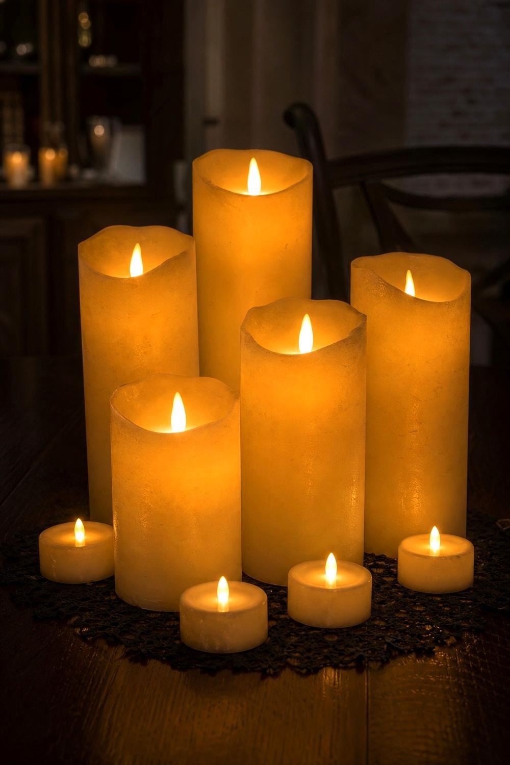 Flameless LED tea lights glowing on a black table runner at dusk