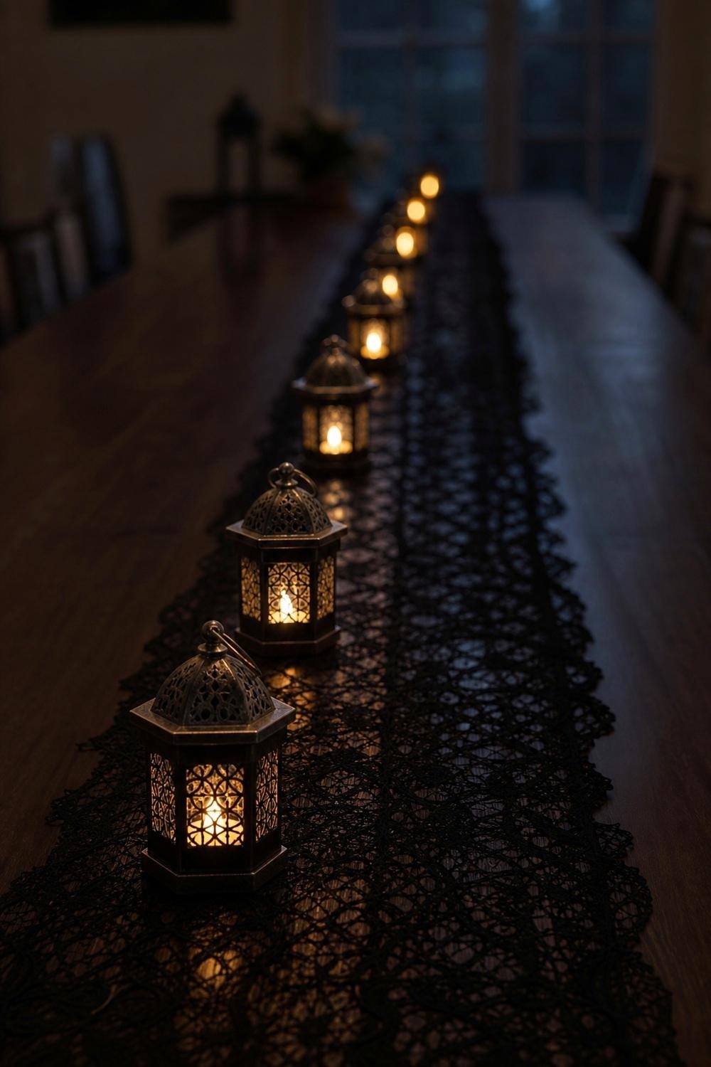 A row of small metal mini lanterns lined down the center of a long dining table