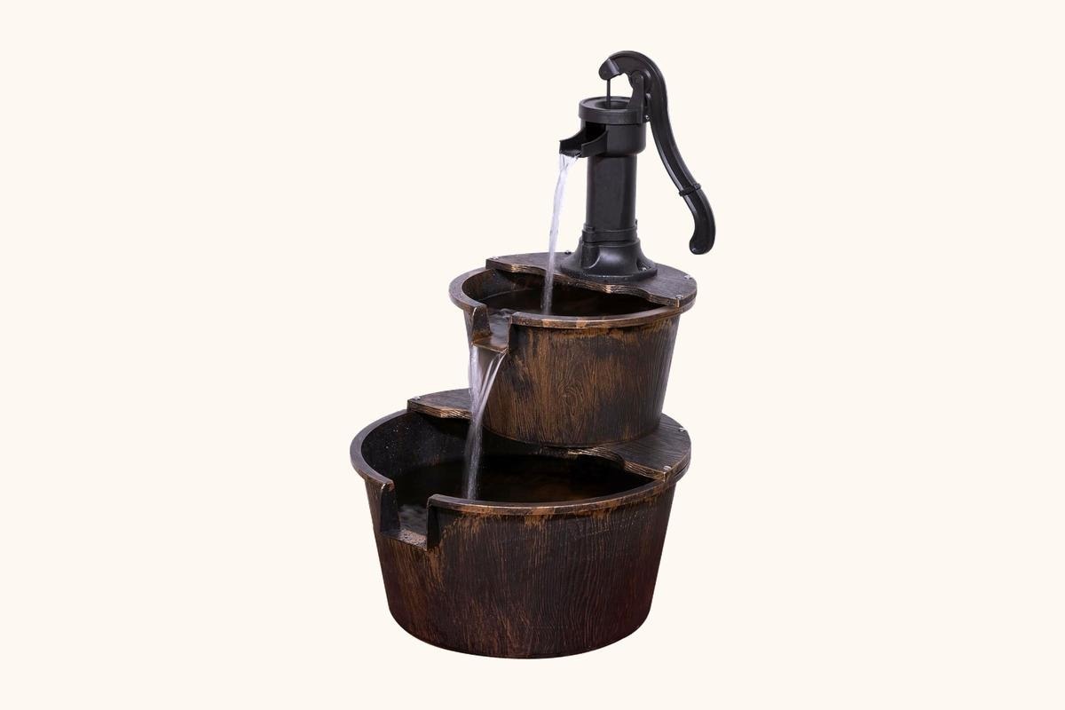 Small solar fountain basin being rinsed beside patio plants